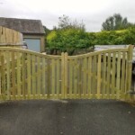 Smooth wooden garden gate crafted by Richard Hope Wooden Gates, featuring a natural finish and decorative wave design for elegant outdoor entryways.